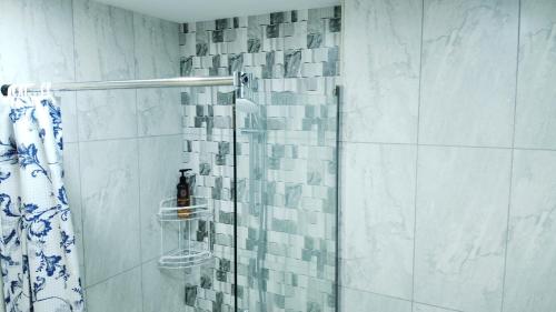 a bathroom with a shower with a glass door at Rima Salalah in Salalah