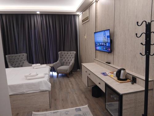 a hospital room with a bed and a tv at Sunset hill in Büyükçekmece
