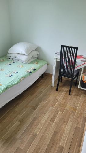 a bedroom with a bed and a desk and a chair at Green House Copenhagen in Copenhagen