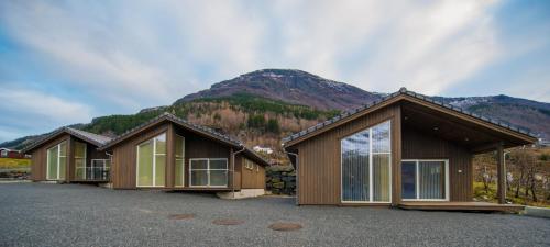 a row of cottages in front of a mountain at Lofthus Camping in Lofthus