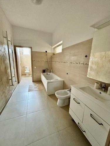 a white bathroom with a toilet and a sink at Vera Residence - Free Private Parking & Self Check-In in Timişoara
