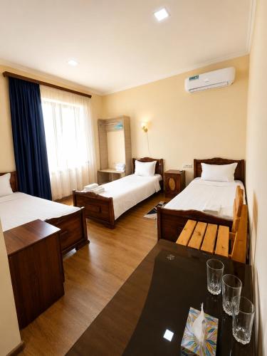 a hotel room with two beds and a table at NUR TOON in Areni