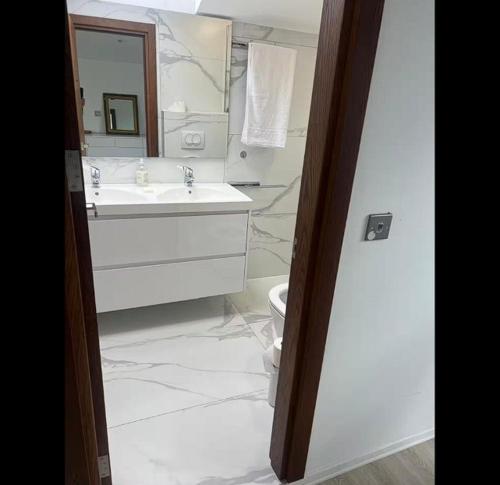 a bathroom with a sink and a toilet and a mirror at Located in a quiet area ! in Durrës