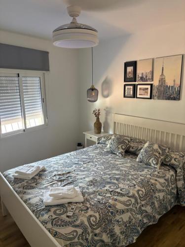 a bedroom with a large bed with a blanket at La casa del papica in Níjar