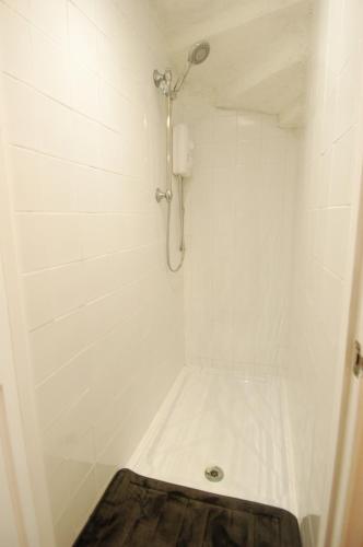 a bathroom with a shower with a toilet in it at Baker Street Retreat in Stirling