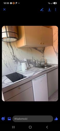 a kitchen with a sink and a counter top at domek 3 osoobowy in Augustów