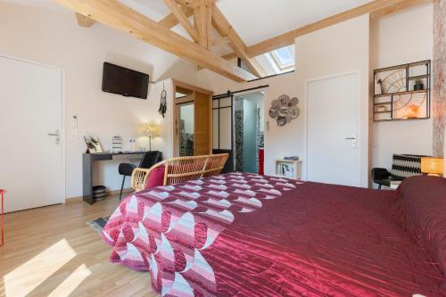 a bedroom with a large bed and a living room at Chambres D'hôtes Le Cocon in Saint-Paul-les-Fonts