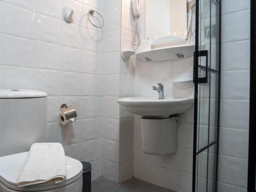 a bathroom with a toilet and a sink and a shower at Karma homes in Turunç