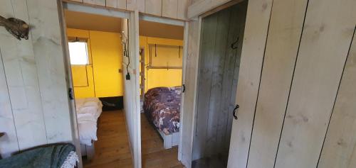 an empty room with a room with a bed in it at Tent Ween at Glamping Verbaarum in Bedum