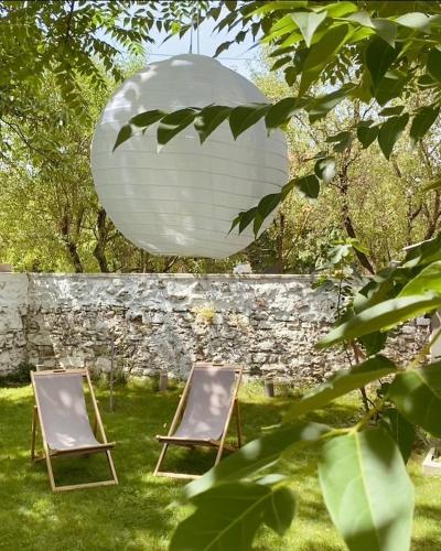 two chairs in the grass next to a orb at Hatablak Boutique Guesthouse in Köveskál in Köveskál