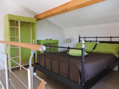 a bedroom with a bed and green walls at Les Provences Bleu et Verte in Solliès-Pont