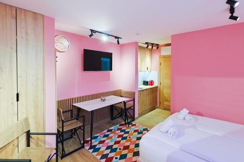 a room with two beds and a pink wall at FourMountains-Igman in Sarajevo