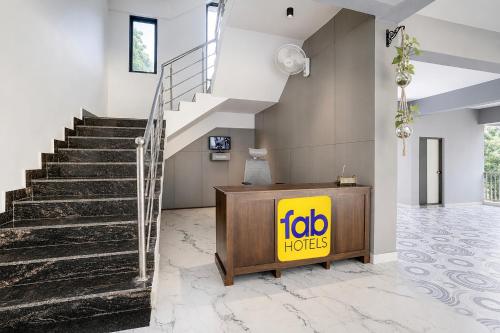 a lobby with a fico hooters sign next to stairs at FabHotel Casa Mandrem in Mandrem