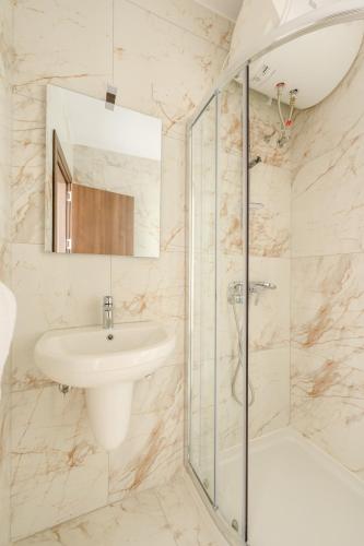 a white bathroom with a sink and a shower at F41 Private room ensuite shared flat in Il-Gżira