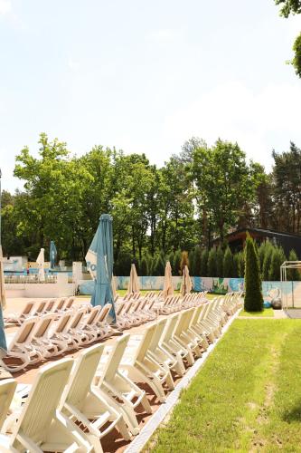 a row of empty lounge chairs with umbrellas at Kryve Ozero in Novoyavorivsk