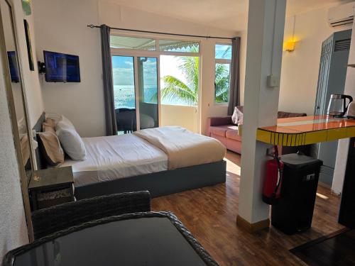 a bedroom with a bed and a view of the ocean at Baywatch Apartment in La Gaulette