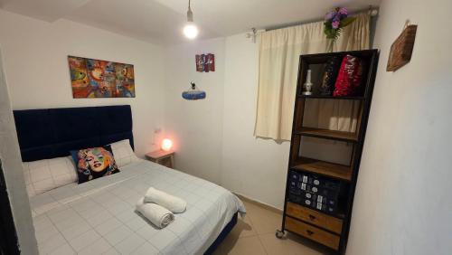 a small bedroom with a bed and a shelf at BOND Grand Suites in Beer Sheva