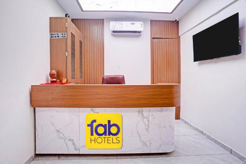 a reception desk in a room with a tv at FabHotel Royal Midway in Gandhinagar