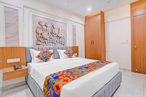 a bedroom with a large bed in a room at FabHotel Royal Midway in Gandhinagar