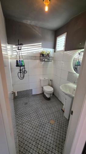 a bathroom with a toilet and a sink at BOND Grand Suites in Beer Sheva