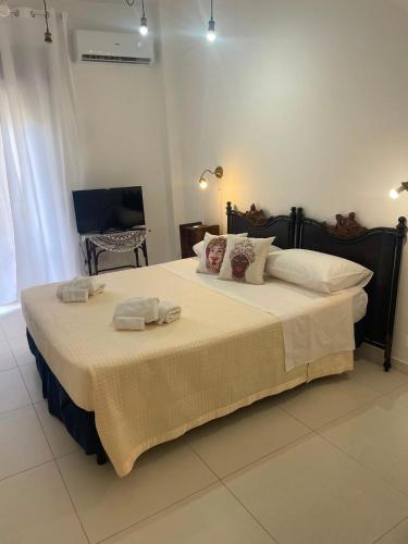 a bedroom with a large bed with towels on it at Casa Luce in Milazzo