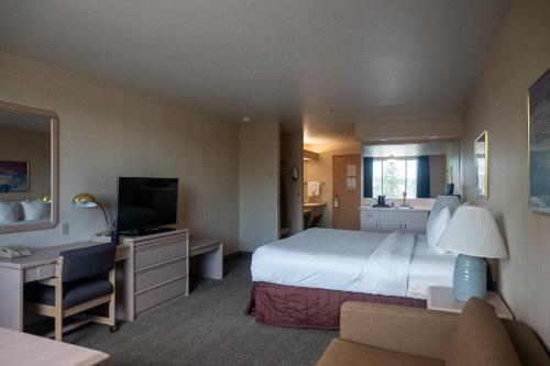 a hotel room with a large bed and a television at Shilo Inn Mammoth Lakes in Mammoth Lakes