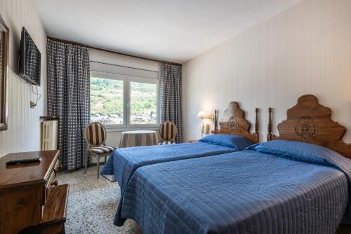 Llit o llits en una habitació de Hotel Delavall