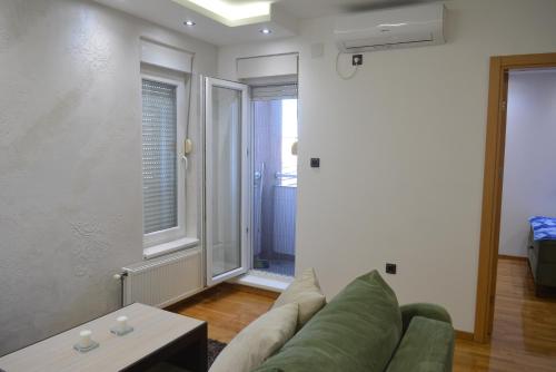 a living room with a couch and a table at Rio Apartmani Ub 3 in Ub