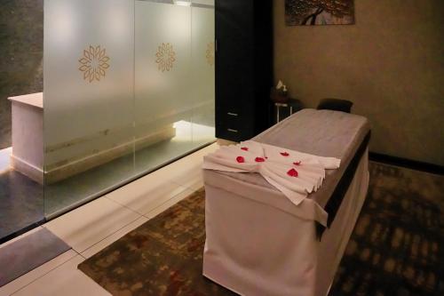 a hospital room with a bed with roses on it at Fraser Suites Muscat in Muscat