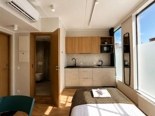 a small room with a bed and a kitchen at Emajõe Apartments in Tartu