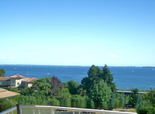 a view of the ocean from a house at Gaestehaus Vogelsang in Sierksdorf