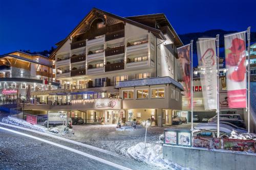 a hotel in the snow at night at Alpen-Herz Romantik & Spa - Adults Only in Ladis