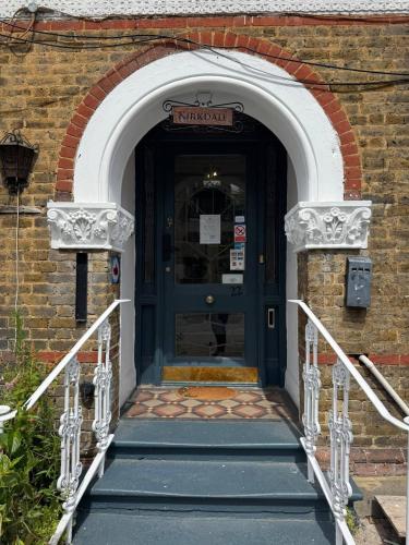 an entrance to a building with a blue door at The Kirkdale Hotel in Croydon