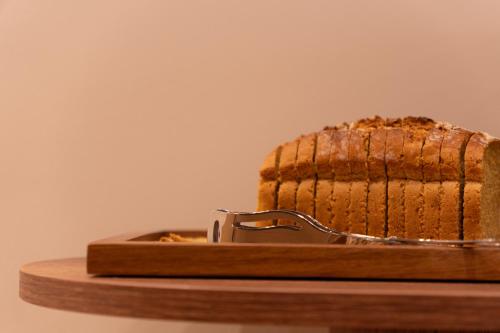 a loaf of bread on a wooden cutting board at Hotel Frochot Montmartre in Paris