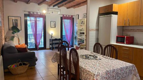 a kitchen with a table and chairs in a room at Flat Plaza de España BCN in Barcelona