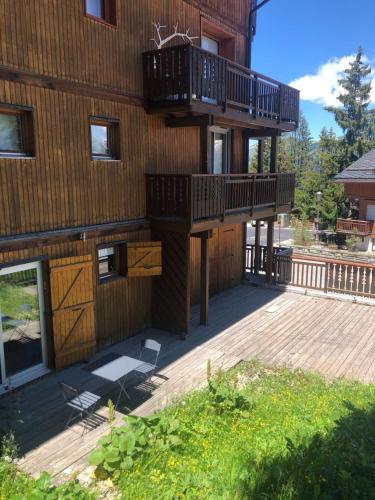 a building with balconies on the side of it at Résidence Les Sapins - Courchevel 1850 in Courchevel