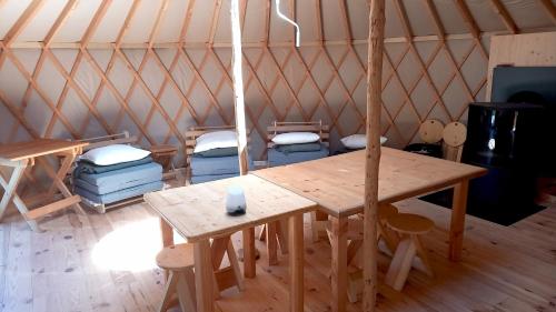 a room with a wooden table and chairs in a yurt at La Yourte Un Autre Monde in Le Hohwald