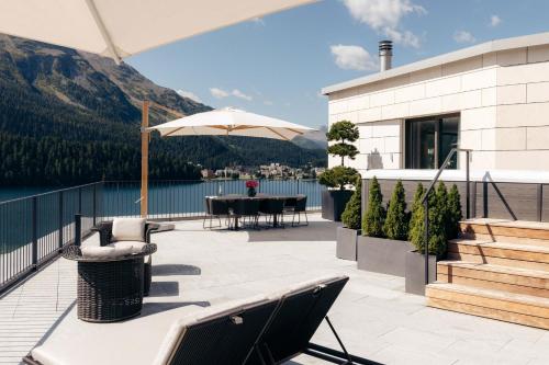 a house with a patio with a table and chairs at Hotel GRACE LA MARGNA ST MORITZ in St. Moritz