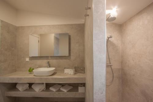 a bathroom with a sink and a shower at Hillside House Residence in Foz do Arelho
