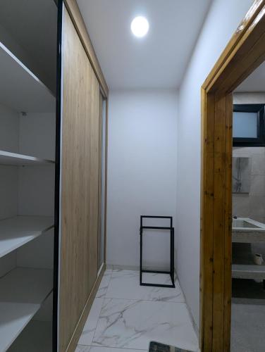 a room with a door and a mirror on a wall at Azmouni in Midoun