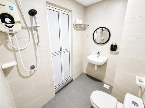a bathroom with a shower and a toilet and a sink at Mutiara Melaka Beach Resort Condominium,Pantai Puteri Melaka in Malacca