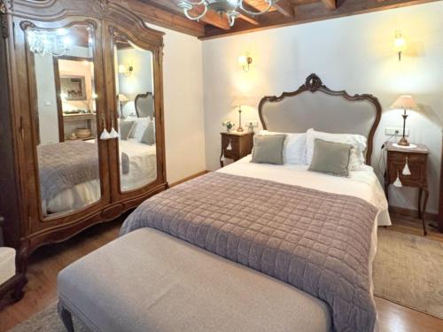 a bedroom with a large bed and a large mirror at Vivienda Vacacional La Cocada VV-144-AS in Arriondas