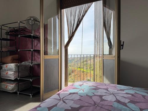 a bedroom with a bed and a large window at Villa Melia Apartments in San Roberto
