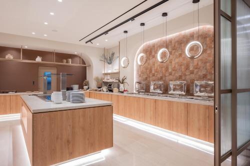 a large kitchen with wooden counters and plates on the wall at Hotel Palmyra in Argassi