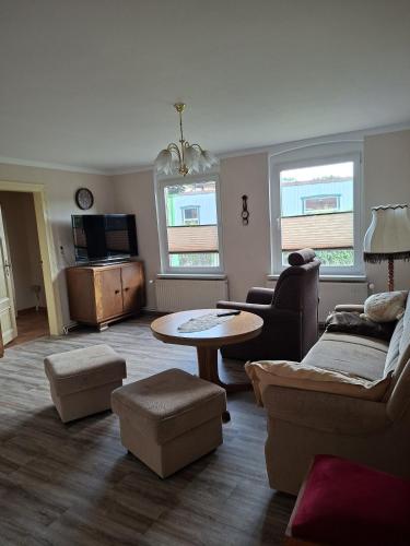 a living room with a couch and a table at Einfamilienhaus 