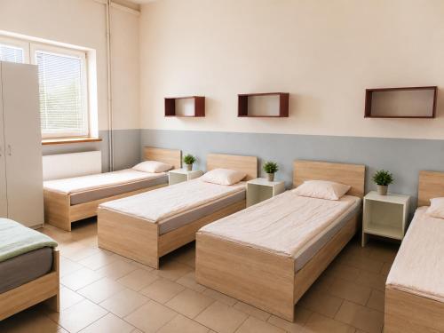 a hospital room with four beds and a window at Kwatery pracownicze in Łódź