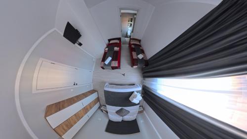 a room with two beds and a window at CASA R&D in Moisei