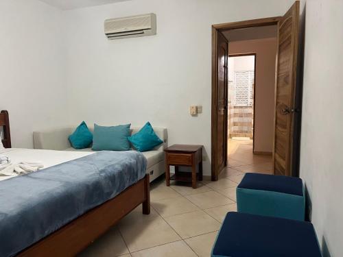 a bedroom with a bed and a table and a chair at Villa Chiara Beachfront Las Terrenas in El Limón