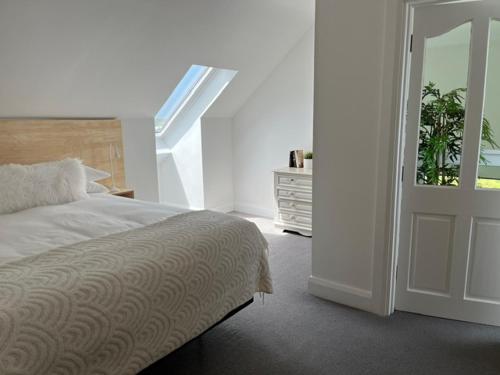 a bedroom with a bed and a sliding door at Leac na Cille in Dingle