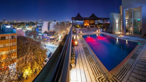 a swimming pool on top of a building at night at Be Hollywood! in Buenos Aires